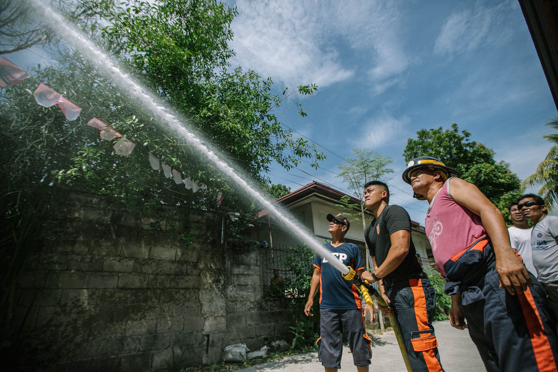 firefighters holding hose